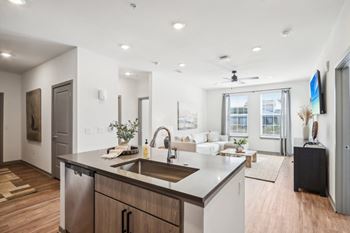 A kitchen with an island and a living room with a couch